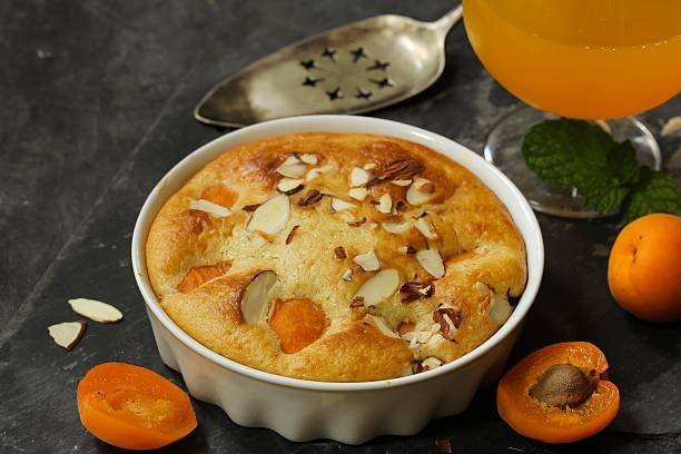 A bowl filled with a delicious apricot dry fruit and almond dessert, showcasing the vibrant colors and textures of the ingredients.