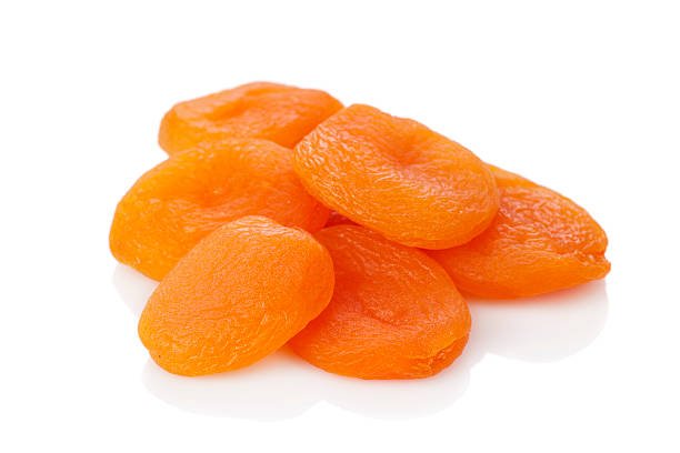 A close-up of dried apricots on the white background.