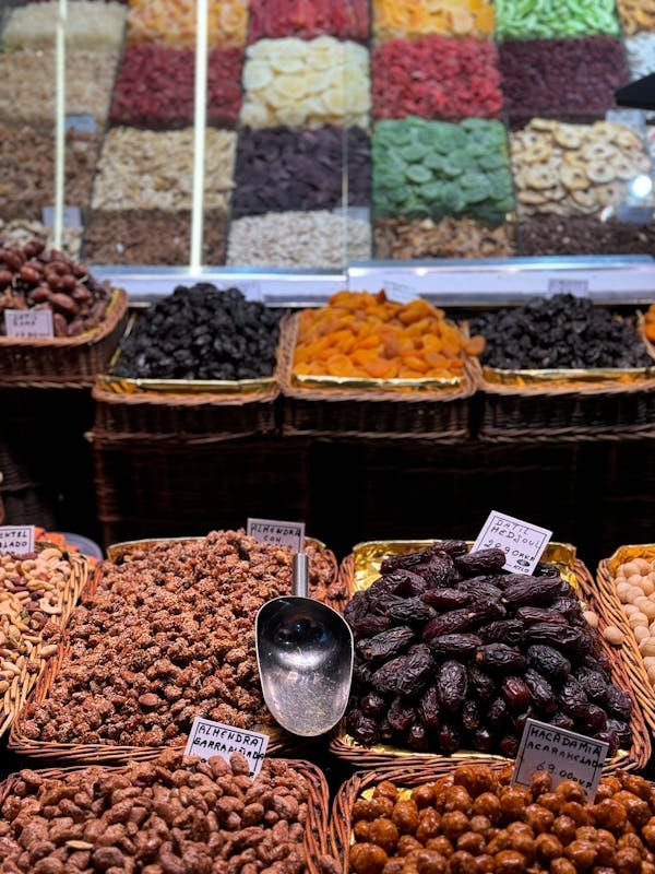 A vibrant assortment of dried fruits and nuts arranged attractively on a wooden display, showcasing their rich colors and textures.