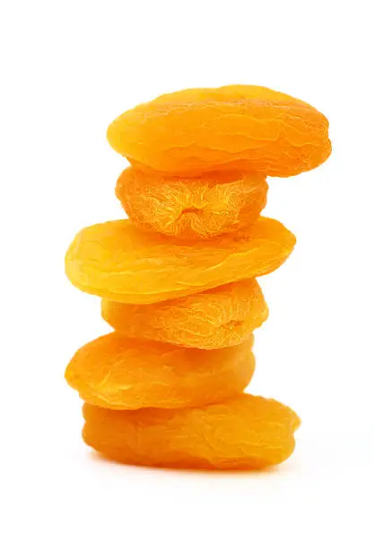 A close-up and down dried apricots on the white background.