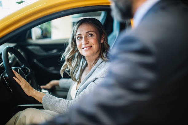 A woman seated in the driver's seat of a car, symbolizing the importance of affordable car insurance options.