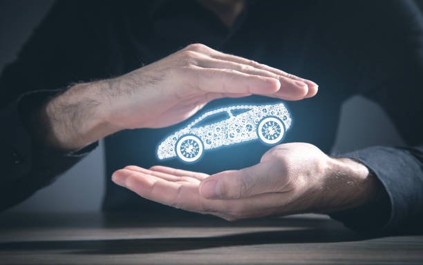 a person's hands protecting a car